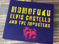 Elvis Costello And The Imposters – Momofuku (NM/vg+) EU-08 minor shelfwear digi