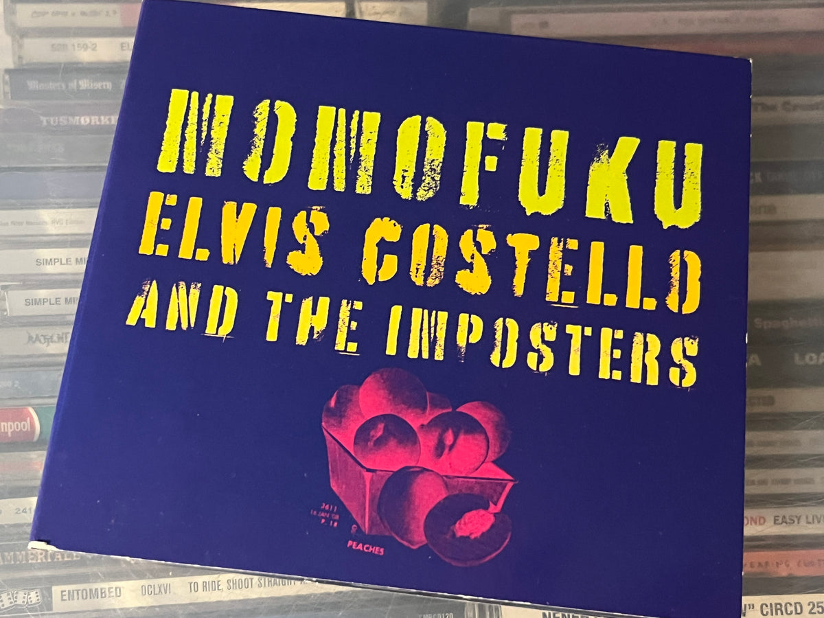 Elvis Costello And The Imposters – Momofuku (NM/vg+) EU-08 minor shelfwear digi