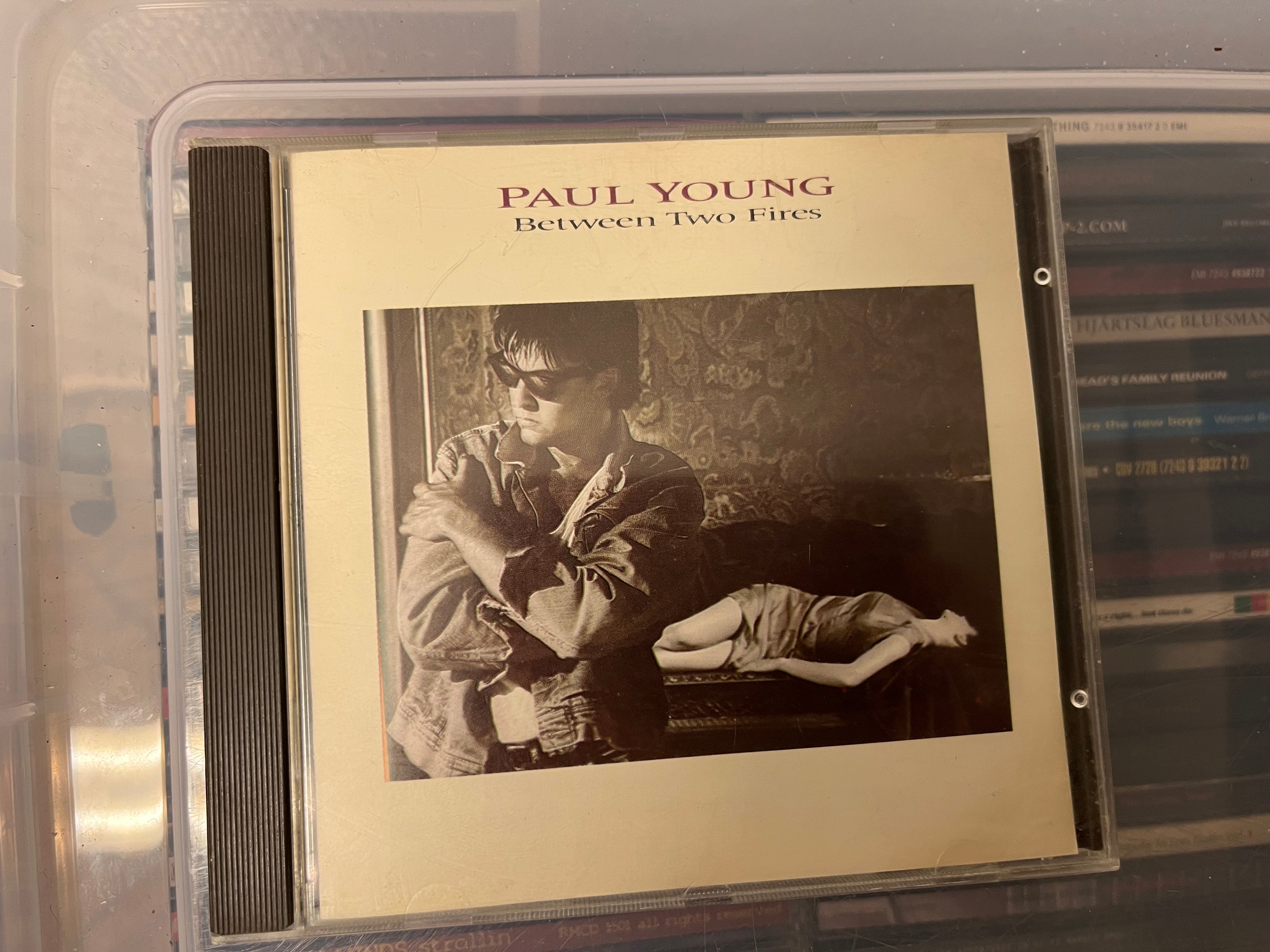 Paul Young – Between Two Fires (vg+/vg+)